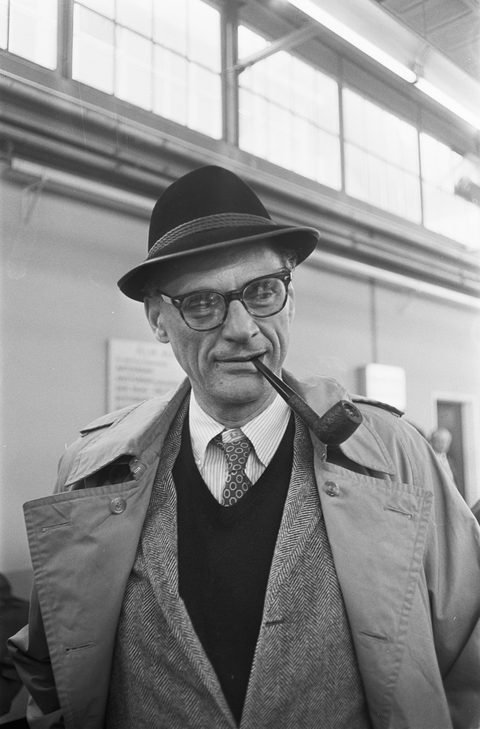 Black-and-white portrait photograph of Arthur Miller at Schiphol Airport in 1966.