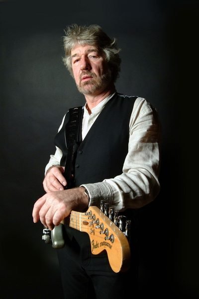 Portrait photograph of playwright Willy Russell in a recording studio.